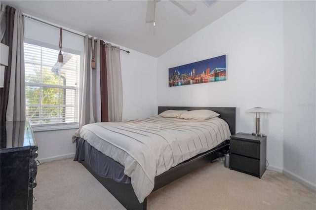 bedroom featuring light carpet, vaulted ceiling, and ceiling fan