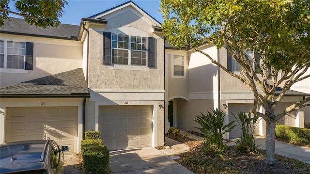 townhome / multi-family property featuring a garage