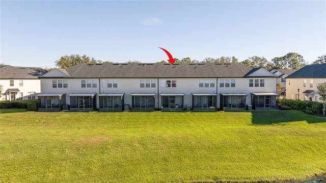 rear view of property featuring a yard and central AC unit