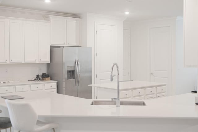 kitchen with stainless steel fridge with ice dispenser, sink, and white cabinets