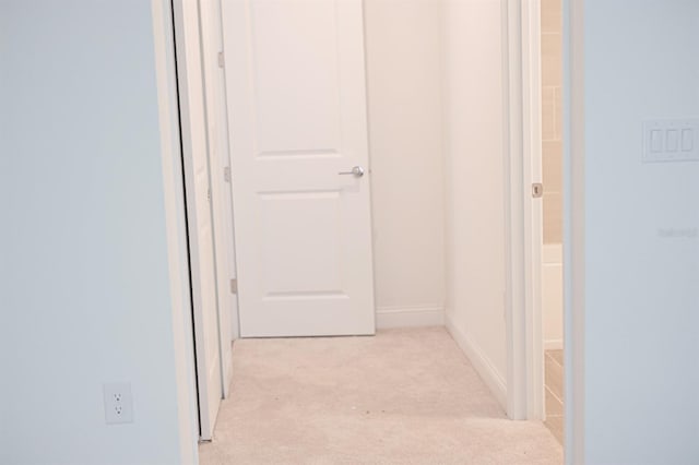 hallway with light colored carpet