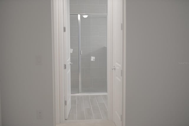 bathroom with tile patterned floors and a shower with shower door