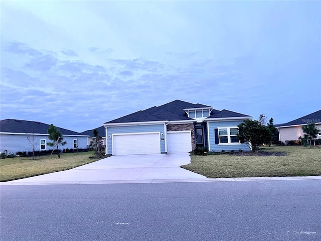 single story home featuring a garage and a front yard