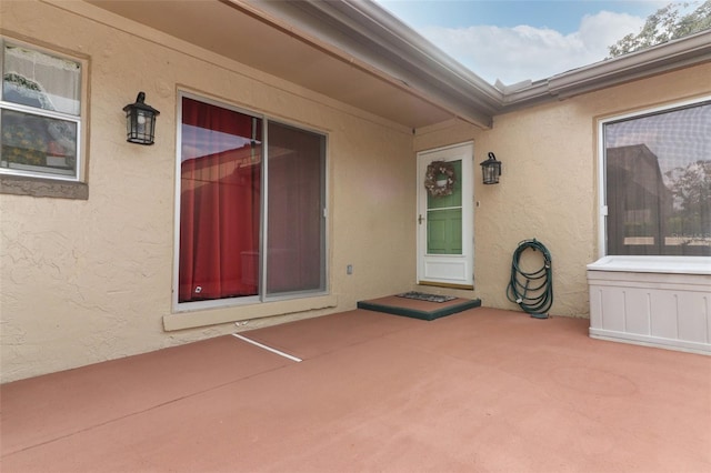 entrance to property featuring a patio area