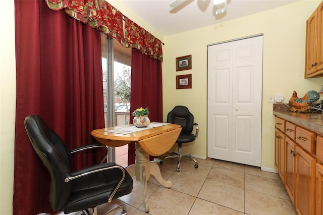 tiled dining space with ceiling fan