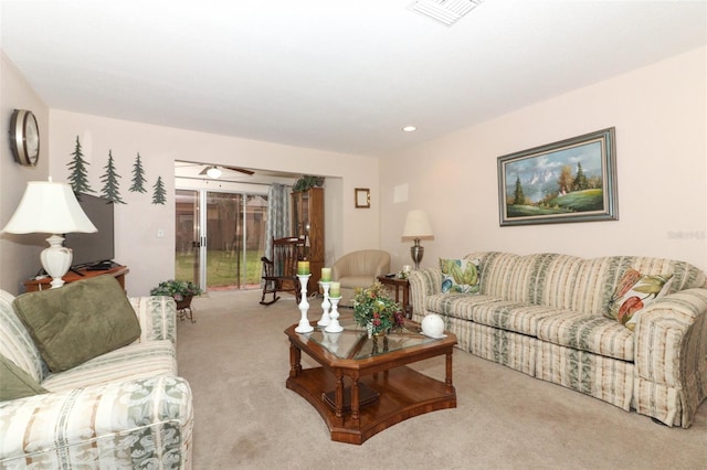 living room featuring ceiling fan and light colored carpet