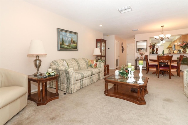 living room with a notable chandelier and light colored carpet