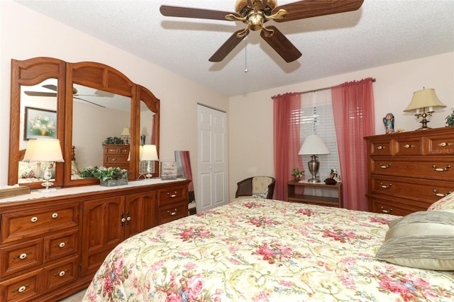 bedroom with a textured ceiling and ceiling fan