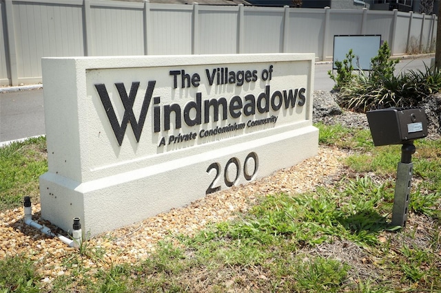 community sign featuring fence