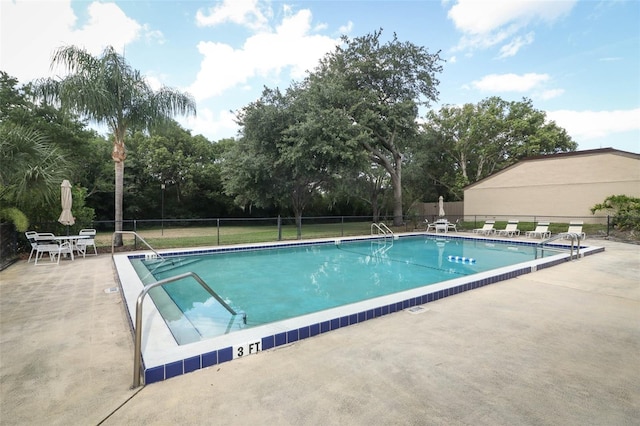 view of swimming pool with a patio area