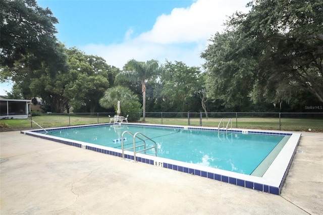 view of pool with a yard