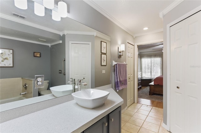 bathroom with vanity, crown molding, ceiling fan, and tile patterned flooring