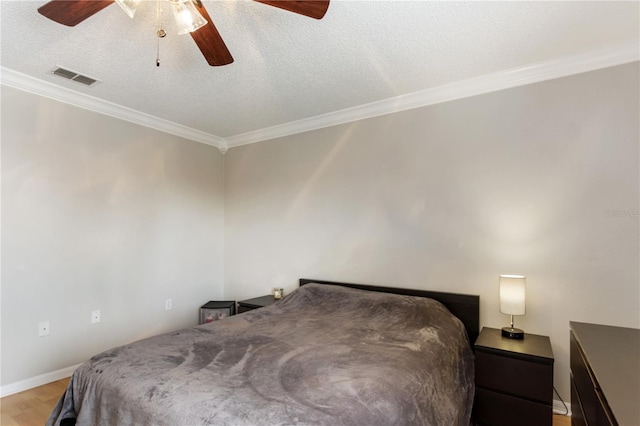 bedroom featuring crown molding, a textured ceiling, light wood-type flooring, and ceiling fan