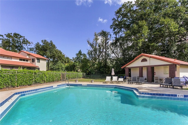 view of swimming pool featuring a patio area