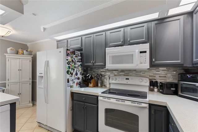 kitchen featuring gray cabinetry, light tile patterned flooring, and white appliances