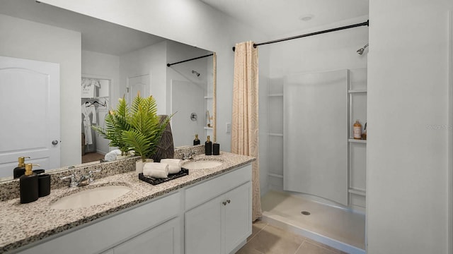 bathroom with vanity, curtained shower, and tile patterned flooring