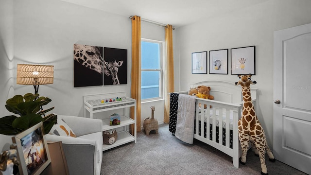 bedroom featuring carpet flooring and a crib