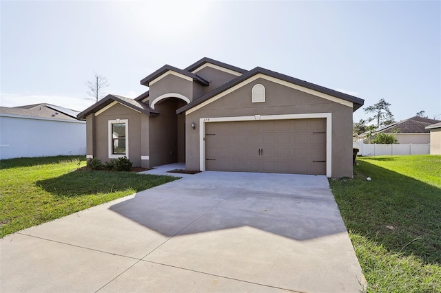 view of front of home with a front yard and a garage