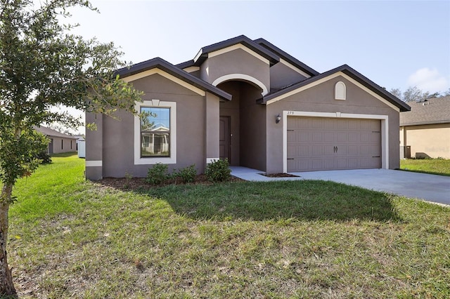 view of front facade with a front lawn and a garage