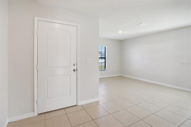 unfurnished room featuring light tile patterned floors