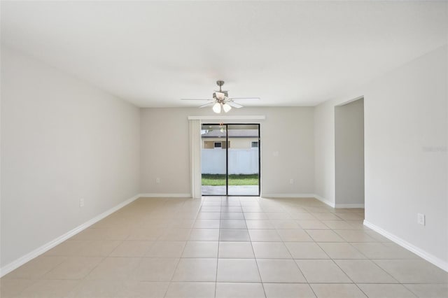 tiled spare room featuring ceiling fan