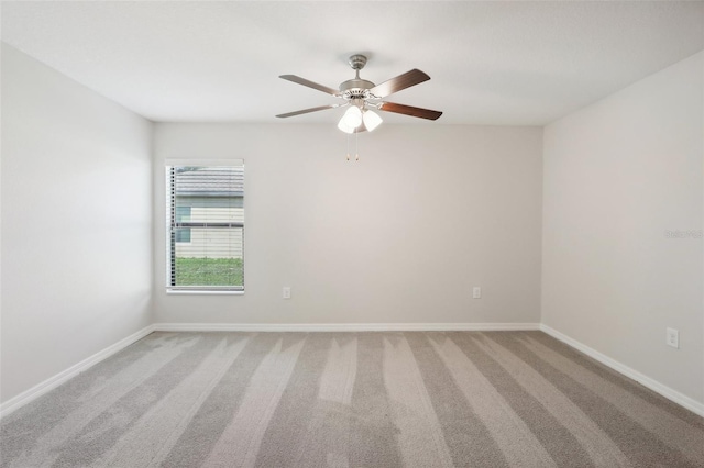 spare room featuring ceiling fan and carpet floors