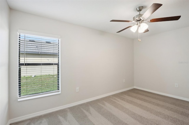 spare room featuring carpet floors and ceiling fan