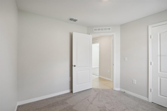 empty room with light colored carpet