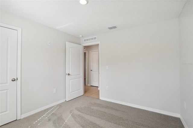 unfurnished bedroom with light carpet