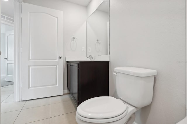 bathroom featuring tile patterned flooring, vanity, and toilet