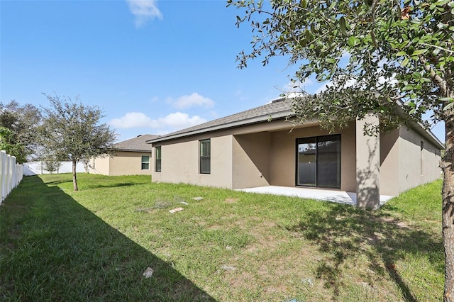 rear view of house featuring a yard