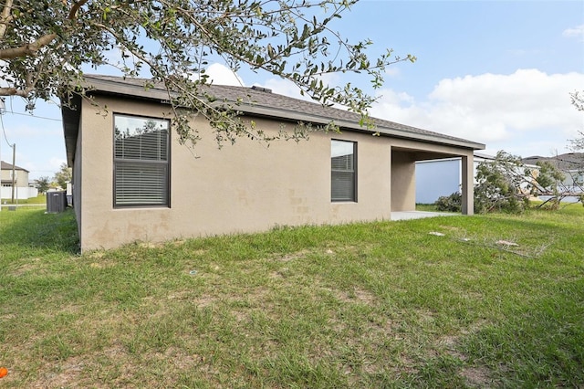 view of home's exterior featuring a yard and central AC