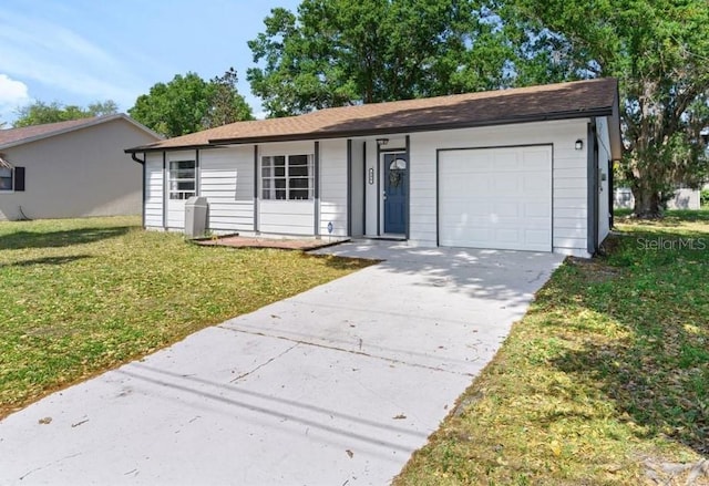 ranch-style house with a garage and a front yard