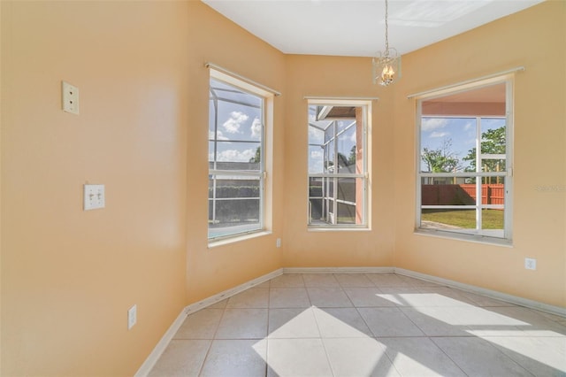 unfurnished dining area with light tile patterned floors and a healthy amount of sunlight