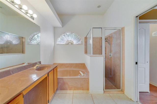 bathroom with vanity, shower with separate bathtub, and tile patterned floors