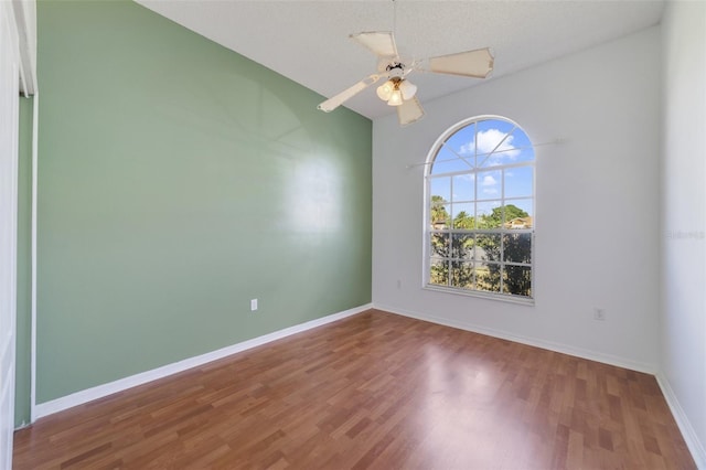 unfurnished room featuring hardwood / wood-style flooring, ceiling fan, and a textured ceiling