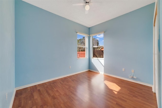 unfurnished room featuring hardwood / wood-style flooring, ceiling fan, and a textured ceiling