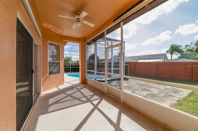 sunroom / solarium featuring ceiling fan