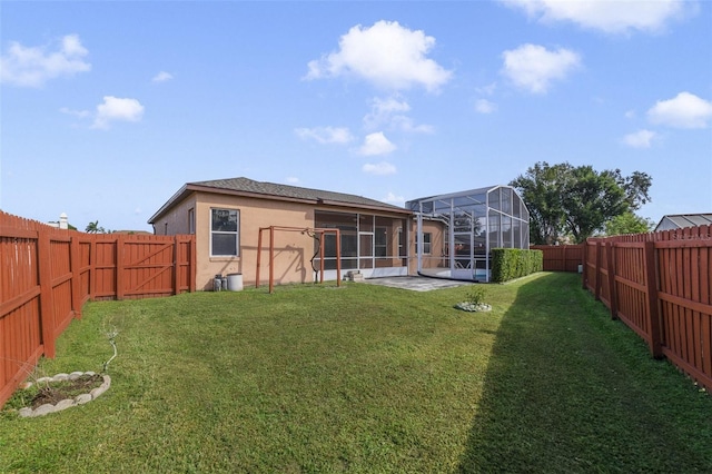 rear view of house with a patio, a sunroom, a yard, and a lanai