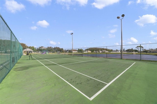 view of sport court with a water view