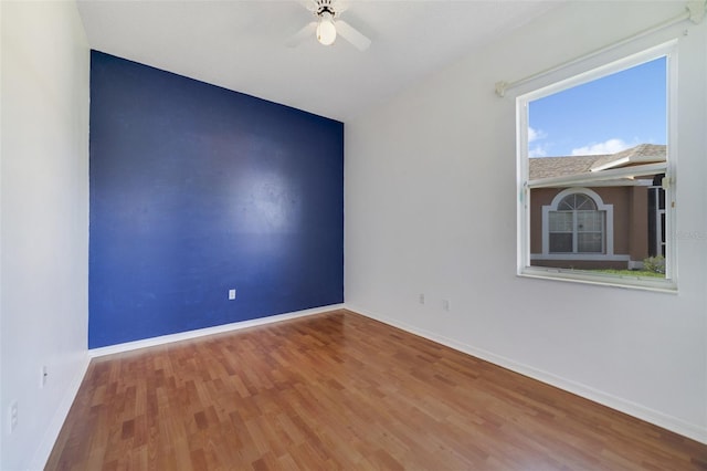 spare room featuring hardwood / wood-style floors and ceiling fan