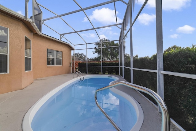 view of pool with a lanai and a patio