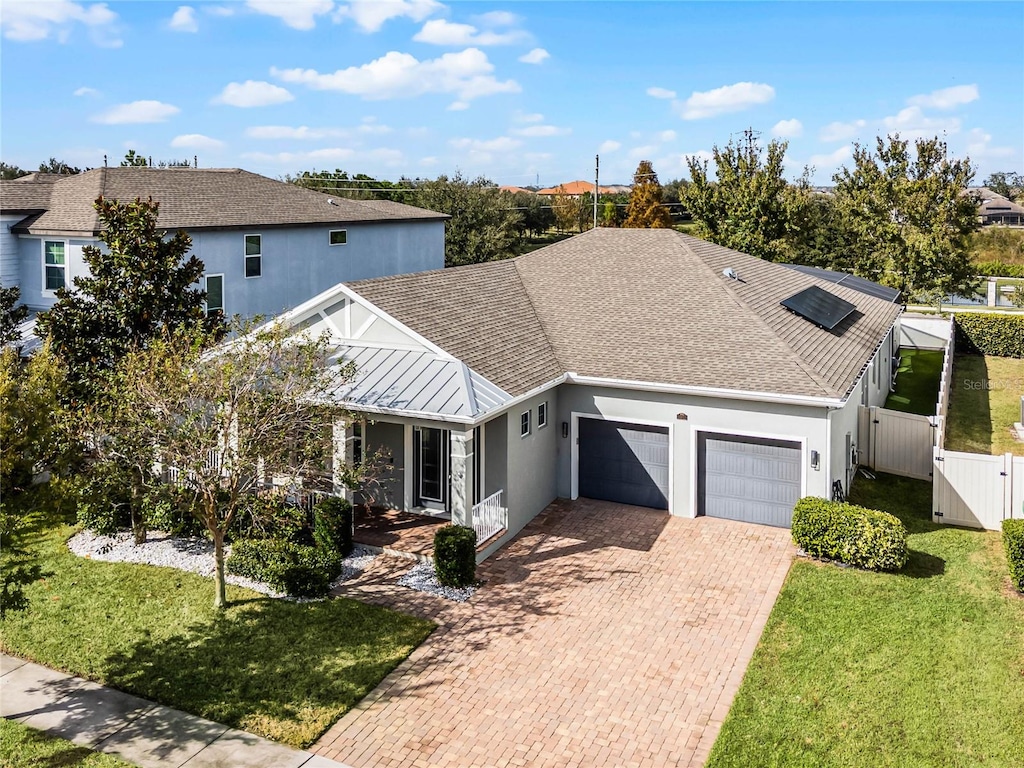 view of front of home featuring a garage and a front lawn