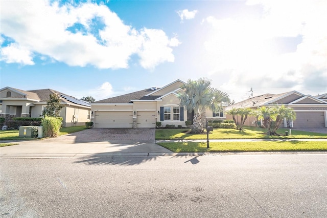 view of front of property featuring a front lawn and a garage