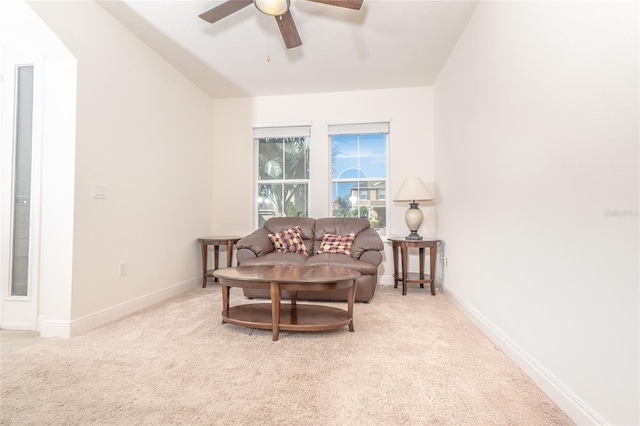 living room featuring ceiling fan, vaulted ceiling, and light colored carpet