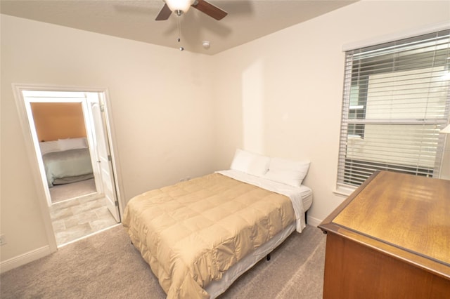 bedroom with light carpet and ceiling fan