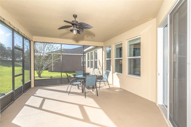 sunroom with ceiling fan