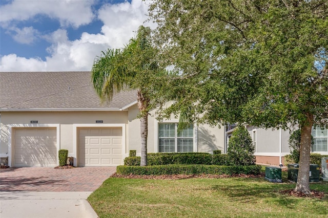 view of front of house with a front lawn and a garage