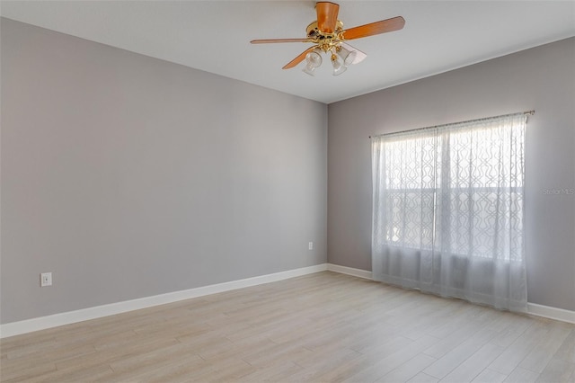 spare room featuring light hardwood / wood-style flooring and ceiling fan