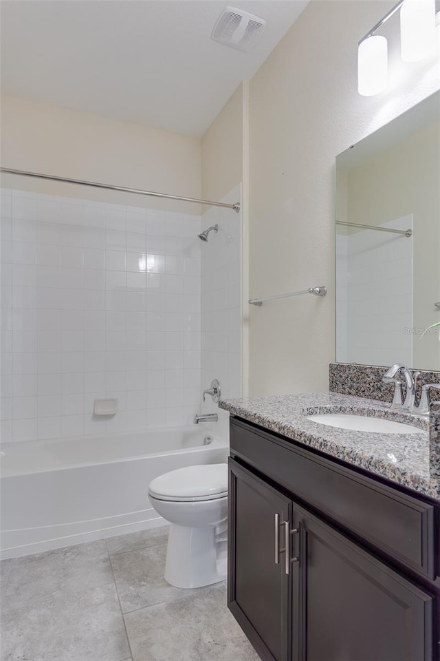 full bathroom with tiled shower / bath, vanity, toilet, and tile patterned flooring